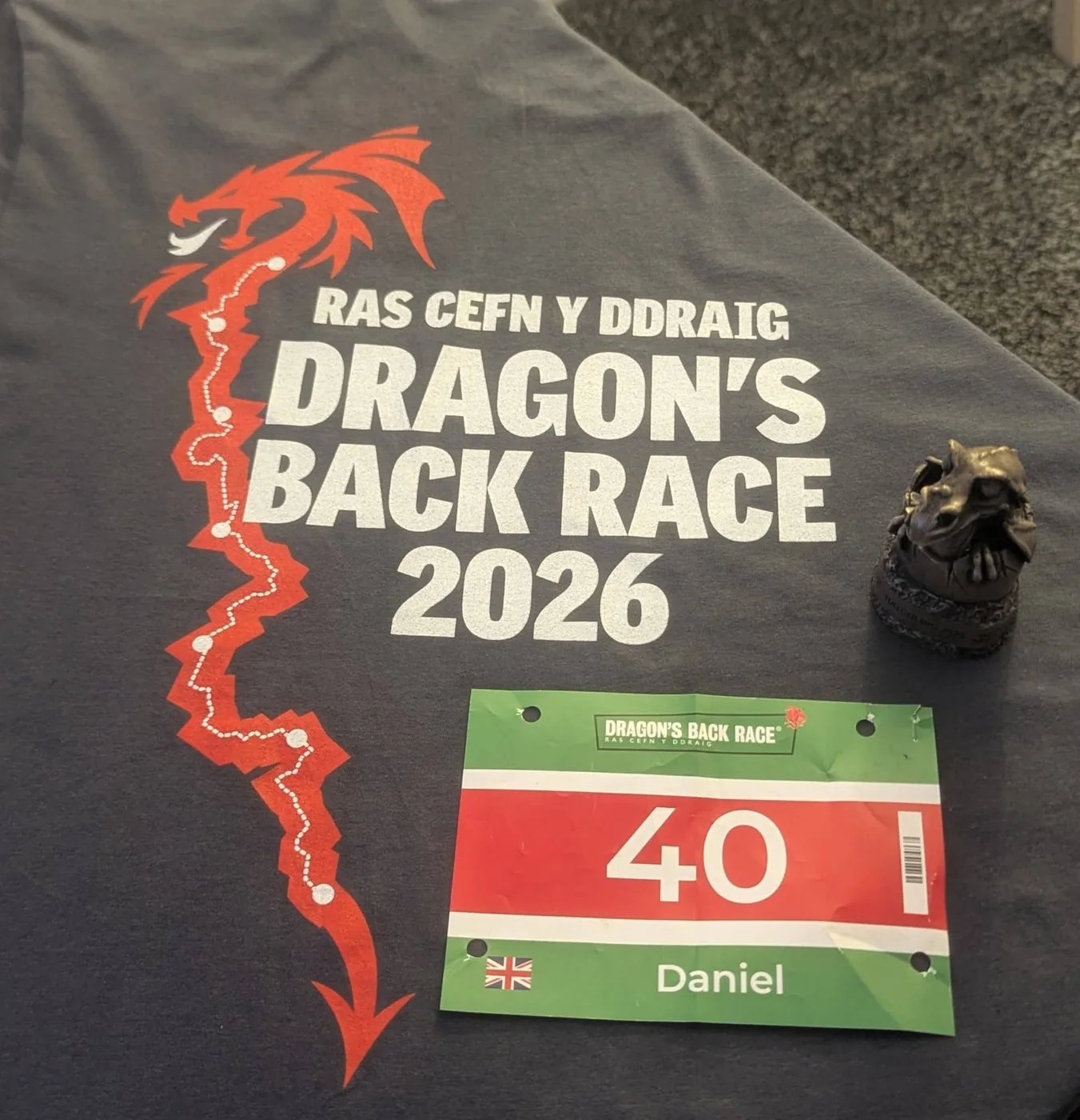The Dragon's Back Race 2026 shirt with the route printed down it in red, beside race number 40 marked Daniel